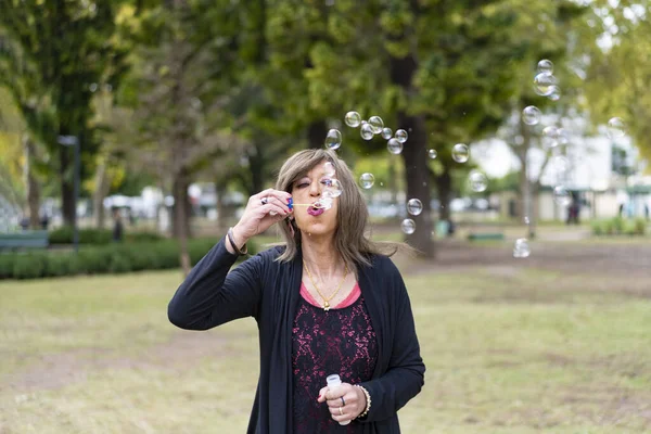Mature Trans Woman Blowing Bubbles Park — 图库照片