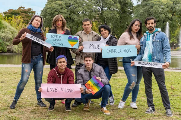 Cheerful queer group holding a message supporting the LGBT community