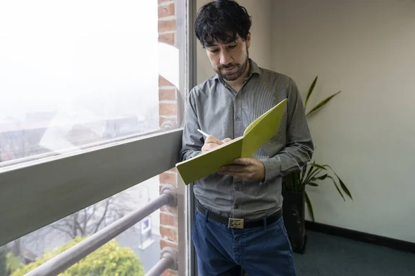 Businessman His Office Standing Window Taking Notes — стоковое фото