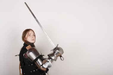 History of the Middle Ages. Portrait of a beautiful medieval female knight in armour on a white background