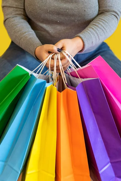 Shopping bags in the woman hands. Joy of consumption. Purchases, black friday, discounts, sale concept.