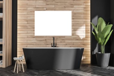 Modern banyo içinde tahta görünümlü duvarda, oval siyah küvetli ve moda taburesinde yatay poster var. Koyu parke tarzı zemin. Ev ve otel tasarımı konsepti. Model yap. 3d oluşturma