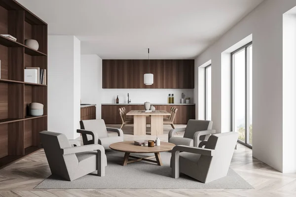 Modern white living space with kitchen in minimalist style, seating area with four armchairs, having beige design, dark wood cabinets and light wood parquet floor. 3d rendering