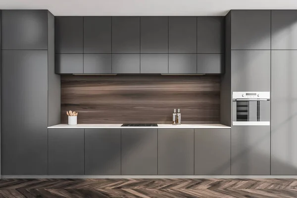 Simple kitchen cabinet interior with dark wood backsplash in niche and parquet flooring. Grey design with modern minimalist concept. 3d rendering