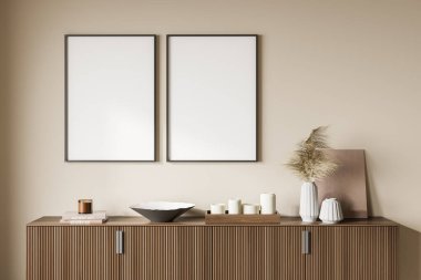 Oturma odasının duvarında, ahşap kaplamalı iki boş tuval. Kitaplar, mumlar ve vazolar üstte. Modern ev tasarımı kavramı. Model yap. 3d oluşturma