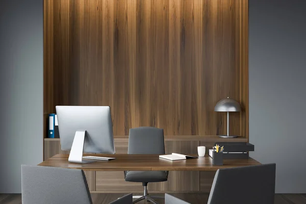 Classy grey executive office with empty wood niche on background. Modern design, using rounded desk, two armchairs for visitors and sideboard. Concept of workspace. 3d rendering
