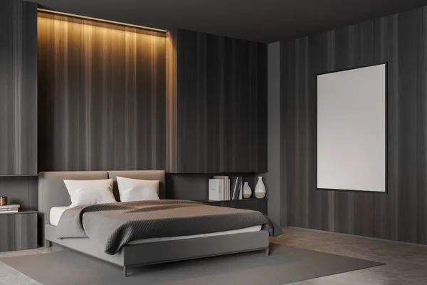 Dark bedroom interior with bed on grey carpet and concrete floor, side view. Nightstand with books and decoration, backlight. Blank copy space canvas on dark wooden wall, 3D rendering