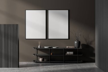 Dekorasyonlu siyah askılı sanat odası, kitaplı seramik vazo, beton zemin olan bekleme odası. Kahverengi duvarda iki kopya alanı çerçevesi, üç boyutlu görüntüleme