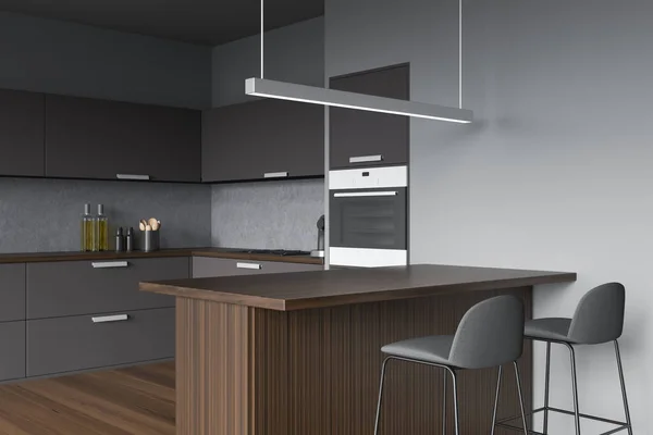 Minimalist interior with grey kitchen corner, linear light, two stools, dark wood bar table and parquet floor. Concept of modern design. 3d rendering