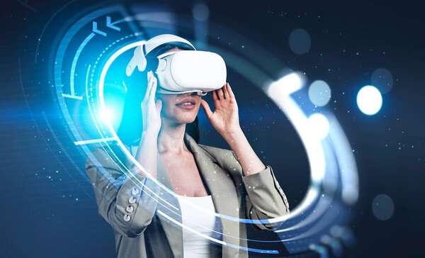 Businesswoman in formal wear is wearing vr helmet. Digital interface with geometrical figures and line connection in the foreground. Dark blue background. Concept of virtual reality
