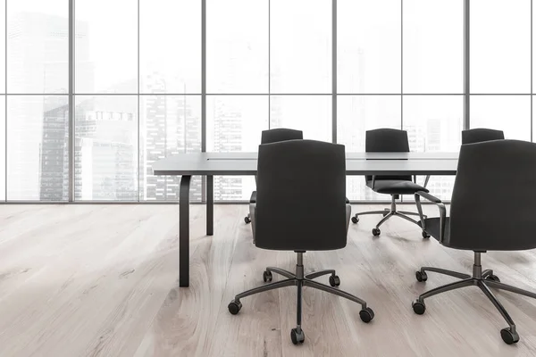 Minimalist meeting room interior with black armchairs and table, light parquet floor. Panoramic window with city view, Singapore skyscrapers, 3D rendering