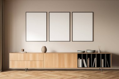 Sanat odası içi ahşap komodinli kitaplar, tabaklı seramik vazo, parke zeminli bekleme odası. Bej duvarda üç kopya alanı çerçevesi, 3 boyutlu görüntüleme