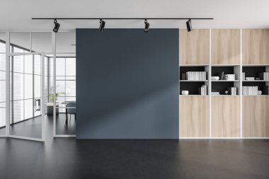 İçi boş mavi duvarlı karanlık ofis odası, masa, koltuk, kitaplarla dolu raf ve beton zemin. Çalışma süreci için mükemmel bir yer. Minimalist tasarım. Model yap. 3d oluşturma