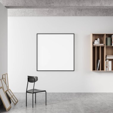 İçi siyah koltuklu, rafı kitaplarla ve dekorasyonla dolu gri beton zeminli sergi odası. Beyaz duvardaki çerçeve kopyalama alanını 3B biçimlendir