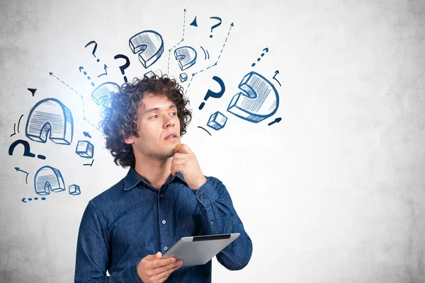 Pondering Young Handsome Businessman Wearing Jeans Shirt Holding Tablet Device — Zdjęcie stockowe