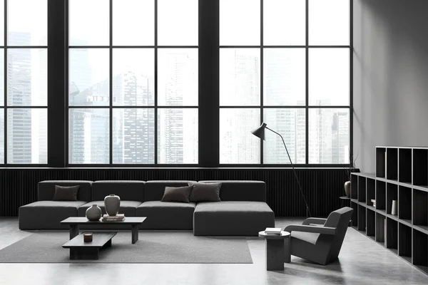 Dark guest room interior with couch, coffee table with decoration on carpet, grey concrete floor, bookshelf. Panoramic window on Singapore skyscrapers. 3D rendering