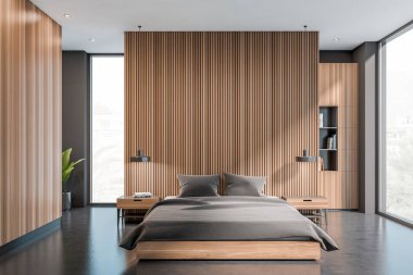 Yatak odasının içi karanlık, panoramik pencere şehir manzaralı, gri duvarlar, ahşap bölme, beton zemin, kitaplar ve başucu. Çağdaş daire tasarımı kavramı. 3d oluşturma