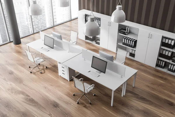 Top view on bright office room interior with desks with desktops, armchairs, panoramic windows, closet with folders and wooden floor. Concept of place for working process and coworking. 3d rendering