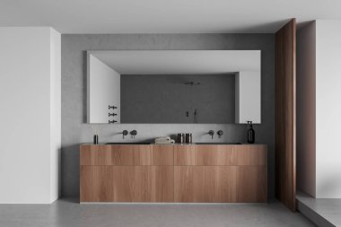 Modern çamaşır odasının içinde çift lavabo ve duvarında büyük bir ayna var. Sabun şişesi, havlu ve kamış ayırıcı güvertede, ön manzara, gri beton zemin. 3B görüntüleme