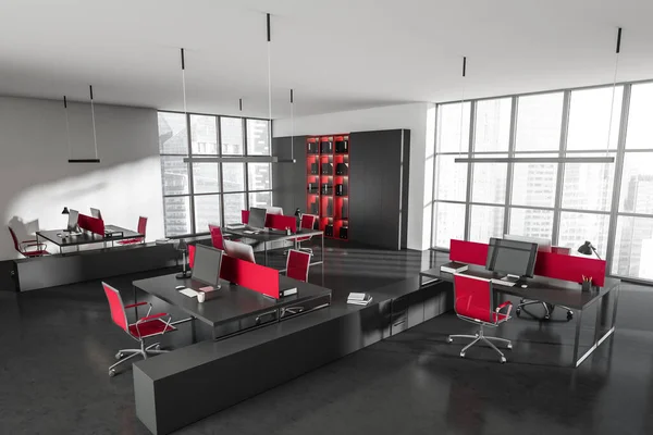 Corner view on dark office room interior with desk with desktop, armchair, panoramic windows, shelves with folder and concrete floor. Concept of place for working process and coworking. 3d rendering