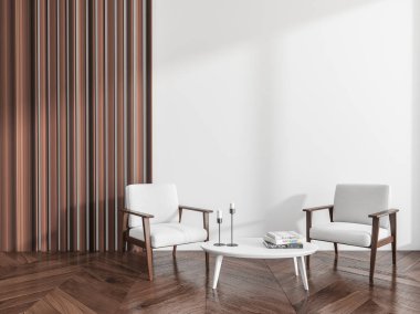 İki koltuk, kitaplar, mumlar ve ahşap zeminli kahve masası olan rahat bir oda. Kopyalama alanı boş beyaz duvar, 3B görüntüleme