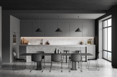 Dark cooking interior with chairs and dining table, island on grey concrete floor, sink with kitchenware. Stylish kitchen with window on countryside, 3D rendering