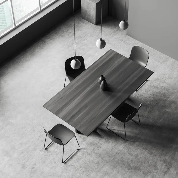 Dark meeting room interior with black chairs and wooden table, top view, panoramic window on city view, grey concrete floor. Stand in the corner. 3D rendering