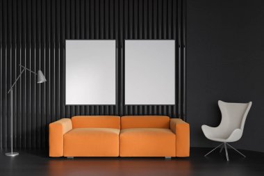 İçi turuncu kanepe ve siyah ahşap zemin üzerinde koltuk olan karanlık soğuk bölge, lambalı misafir odası. Sıraya dizilmiş iki boş poster, 3 boyutlu görüntüleme