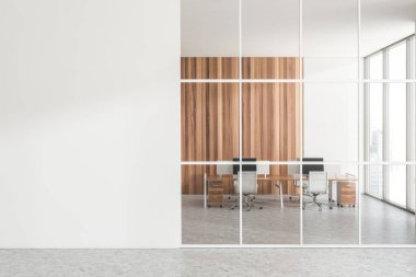 White office room interior behind glass doors, armchairs with pc computer on desk, grey concrete floor. Window with city view. Mock up copy space white wall. 3D rendering