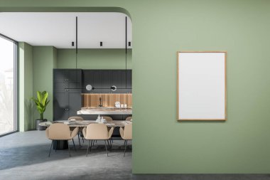 Green kitchen interior with chairs and dining table on grey concrete floor, eating space with panoramic window on countryside. Mockup canvas poster. 3D rendering