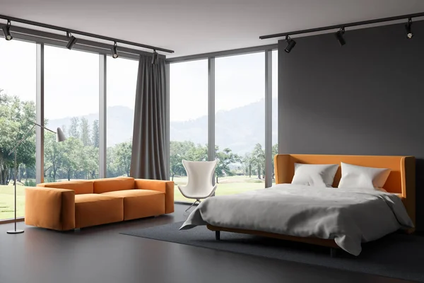 Dark relax room interior with sofa and bed on carpet, armchair and panoramic window on countryside. Modern open space bedroom on hardwood floor. 3D rendering