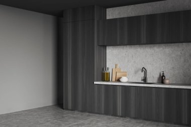 Corner view on dark kitchen room interior with empty grey wall, cupboard, sink, crockery, cooking desk, concrete floor. Concept of minimalist design. Space for creative idea. Mock up. 3d rendering