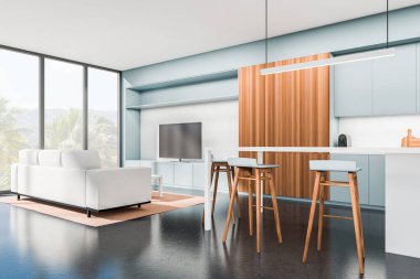 Light blue kitchen interior with sofa, tv set and island with bar chairs. Modern studio with relax and cooking space. Panoramic window on countryside. 3D rendering