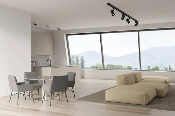 Corner view on bright studio room interior with dining table with chairs, panoramic window, cupboard, large sofa, oak wooden floor. Concept of minimalist design. Space for creative idea. 3d rendering