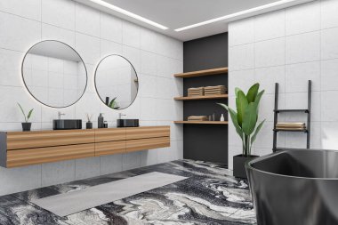 Corner view on dark bathroom interior with bathtub, two round mirrors and sinks, liquid soap, white walls, carpet, houseplant, shelf with towels, marble tile floor. 3d rendering