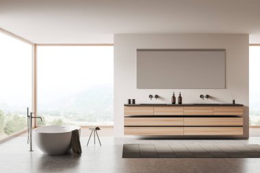 Beyaz banyo içi, küvet karıştırıcısı monte edilmiş gri beton zeminde havlularla dolu bir masa. Aynalı çift lavabo, aksesuarlı güverte. Kırsal kesimde panoramik pencere. 3B görüntüleme