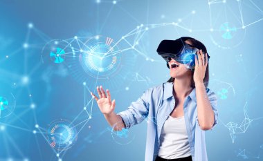 Smiling businesswoman in formal wear is wearing vr helmet. Pie diagrams with binary code and line connection in the foreground. Blue background. Concept of virtual reality and successful business