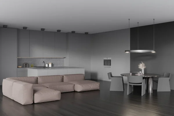 Corner view on dark kitchen room interior with sofa, dining table with armchairs, cupboard, oven, grey wall, sink, oil and oak wooden floor. Concept of minimalist design. 3d rendering