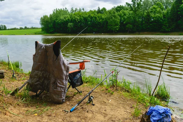 Fisherman Chair Equipment Shore Lake Reflections Clouds Water Fishing Concept — Foto Stock