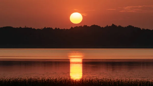 peaceful summer landscape on the lake at dawn, dusk, colors of the sky before sunrise, sunrise on the lake, Lake Burtnieki, Latvia