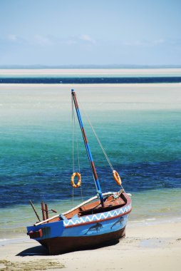 Dhow at the water's edge, Mozambique. Portrait clipart