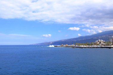 November 20 2021 - Puerto de la Cruz, Tenerife, Canaries: harbor and coastline in the sun