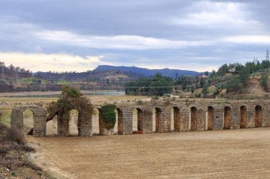 a view of viaduct arch bridge near small village in turkey