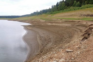 August 25 2018 - Lehnmuehle, Saxony, Germany: dried up empty reservoir and dam during a summer heatwave, low rainfall and drought in Saxony, Germany, Talsperre Lehnmuehle