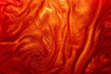 Odaklanmamış soyut arkaplan. Soyut zarif, detaylı kırmızı parıltı parçacıkları su altında küçük bir alan derinliği ile akıyor. Sihirli parlak arkaplan.