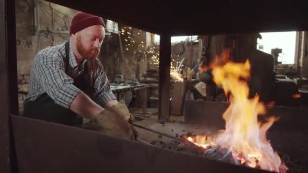 Blacksmith Apron Protective Gloves Turning Burning Coal While Tending Fire — Stock Video
