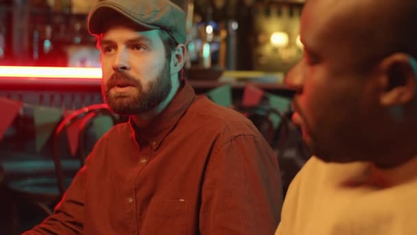 Medium Close Portrait Two Ethnically Diverse Men Sitting Together Pub — Stock Video