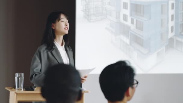 Junge Asiatin Lächelt Und Präsentiert Kollegen Auf Architekturkonferenz — Stockvideo