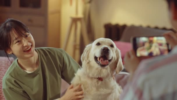 Jovem Mulher Asiática Abraçando Bonito Cão Golden Retriever Sorrindo Para — Vídeo de Stock