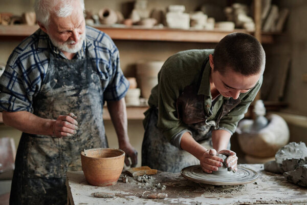 Pottery artist working on pottery wheel